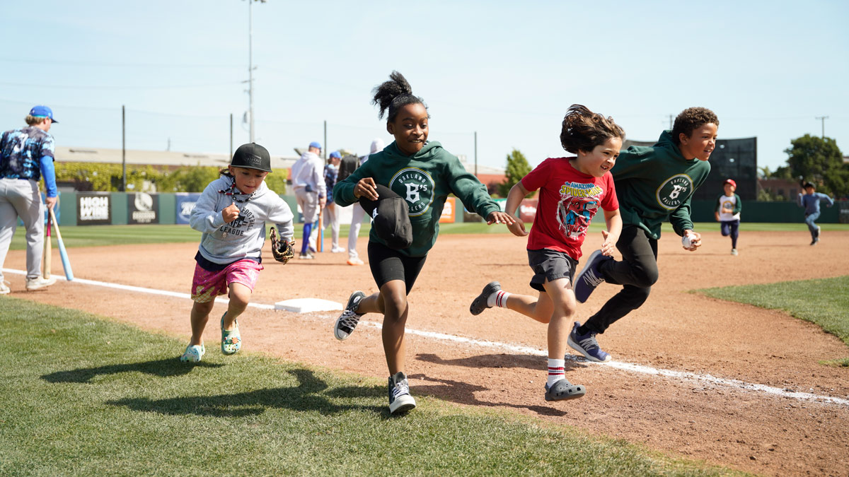 Kids run the bases on the field at Raimondi Park